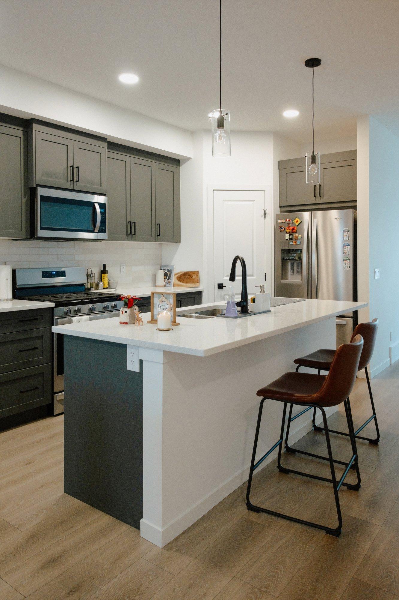 As part of the deal, the couple got to select some of their new home's finishes, like these dark grey kitchen cabinets.