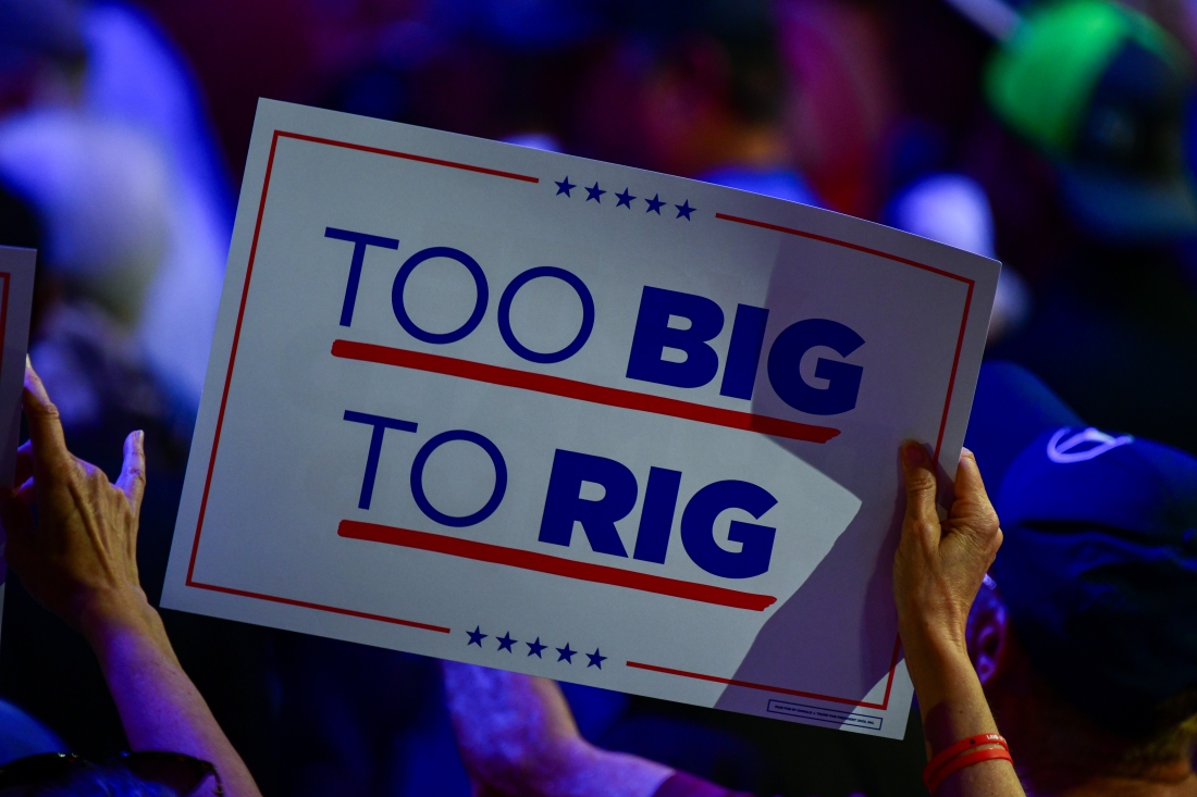 A supporter waves a sign in support of Former President Donald Trump at Dream City Church in Phoenix, Ariz. on Thursday, June 6, 2024.