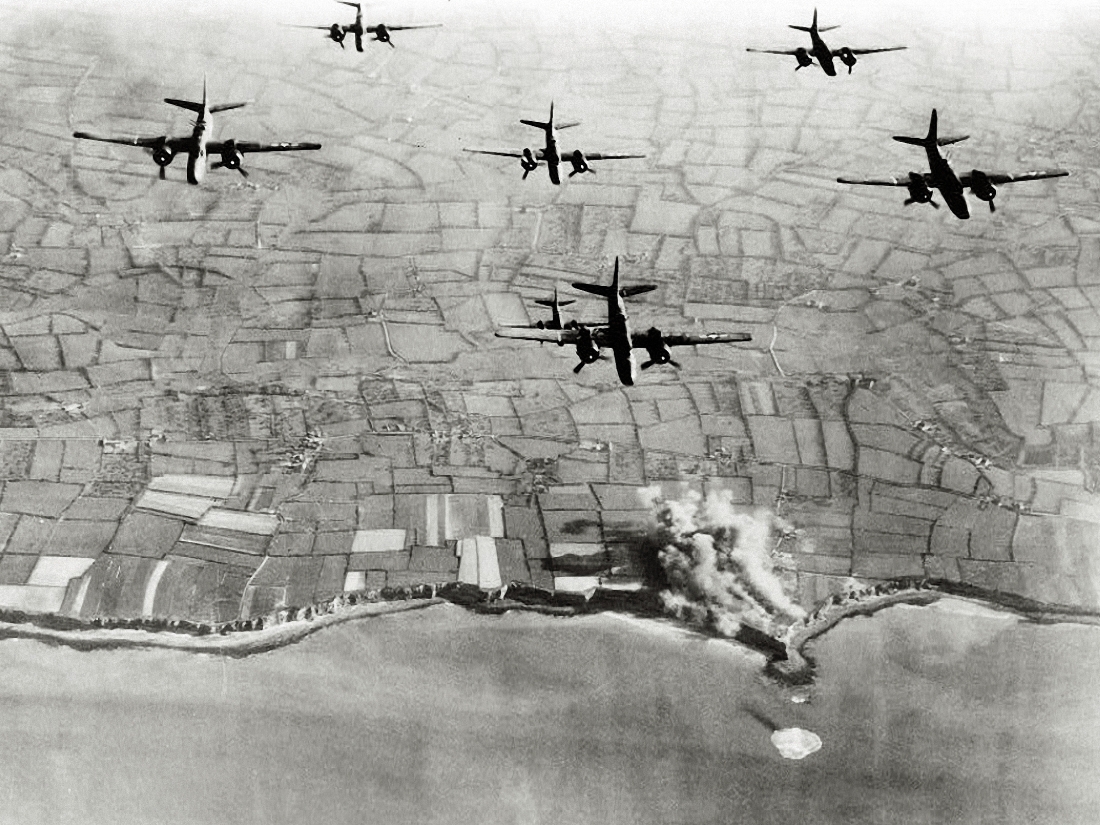 An aerial view of bombers flying over Pointe du Hoc.