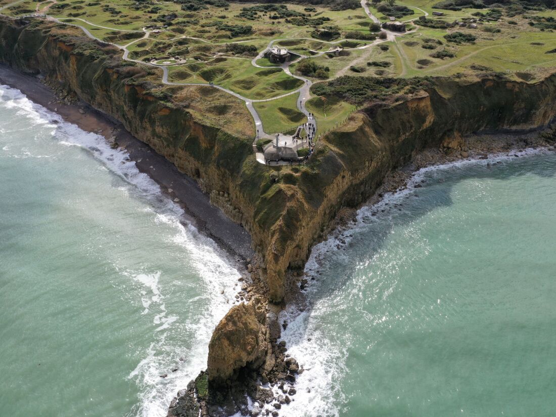 An aerial view of Pointe du Hoc, jutting out over the water.