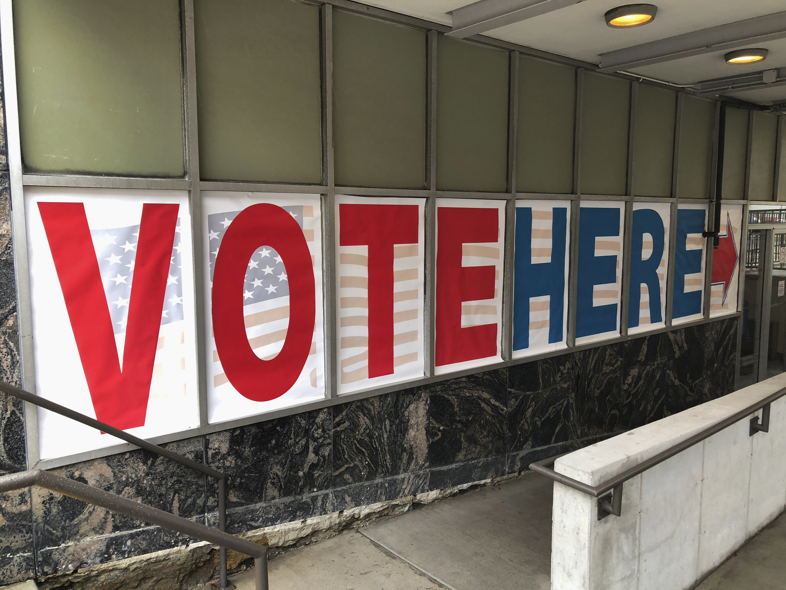 A "vote here" sign marks the entrance to an early voting station in downtown Minneapolis in 2018.