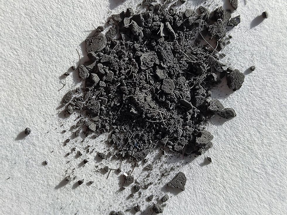 A small pile of dark gray powdery material