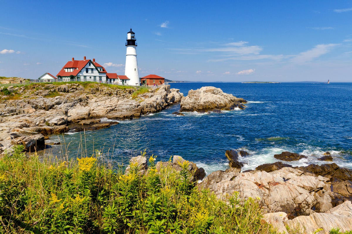 A bright summer afternoon at Portland Head Lighthouse in Fort Williams Park on Cape Elizabeth in Portland, Maine.