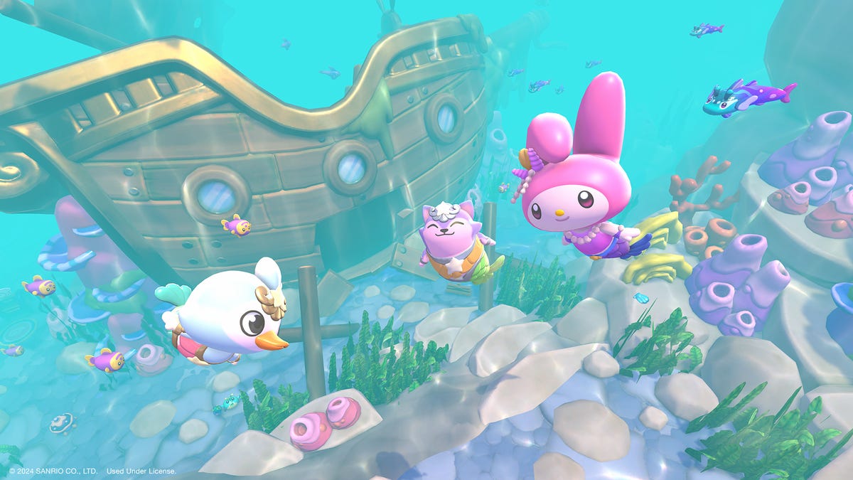 Characters in mermaid tails swim underwater near a sunken shipwreck.