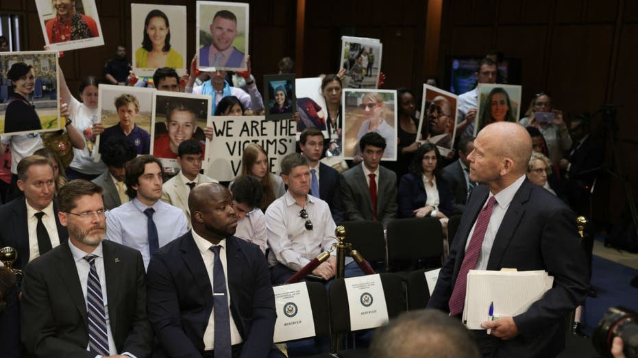 Boeing CEO Dave Calhoun looks a victims' families during hearing