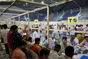 Election staff members count votes for India's general election inside a vote counting centre in Kolkata, India