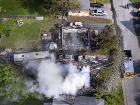 Auburn firefighters hose down the remains of home