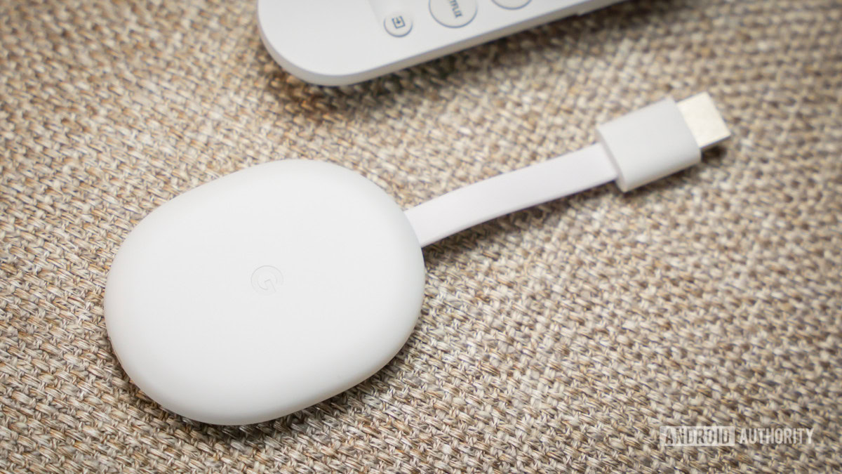 Chromecast with Google TV HD next to remote 5