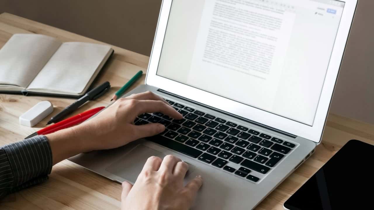 Female hands typing laptop proofreading