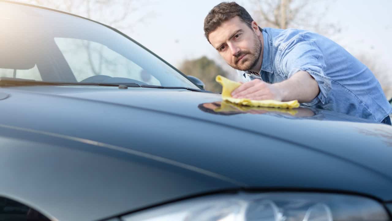 Man taking care and cleaning his car