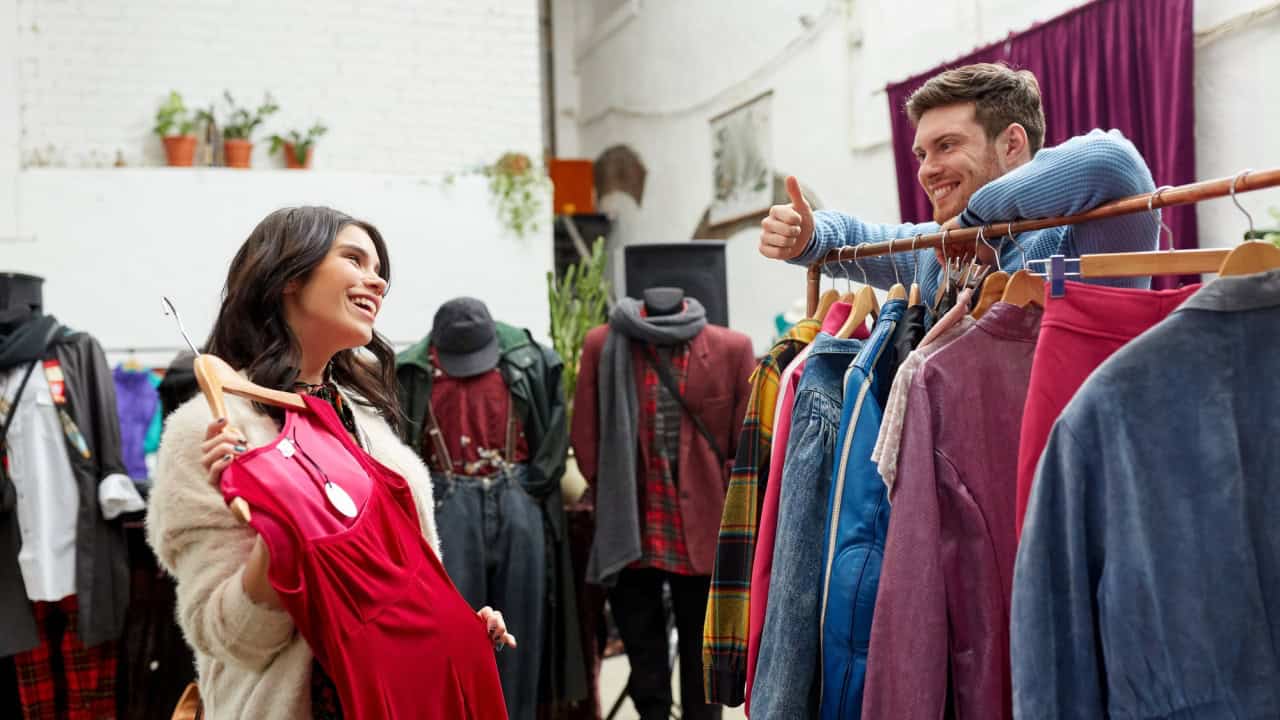 Couple choosing clothes at vintage clothing store