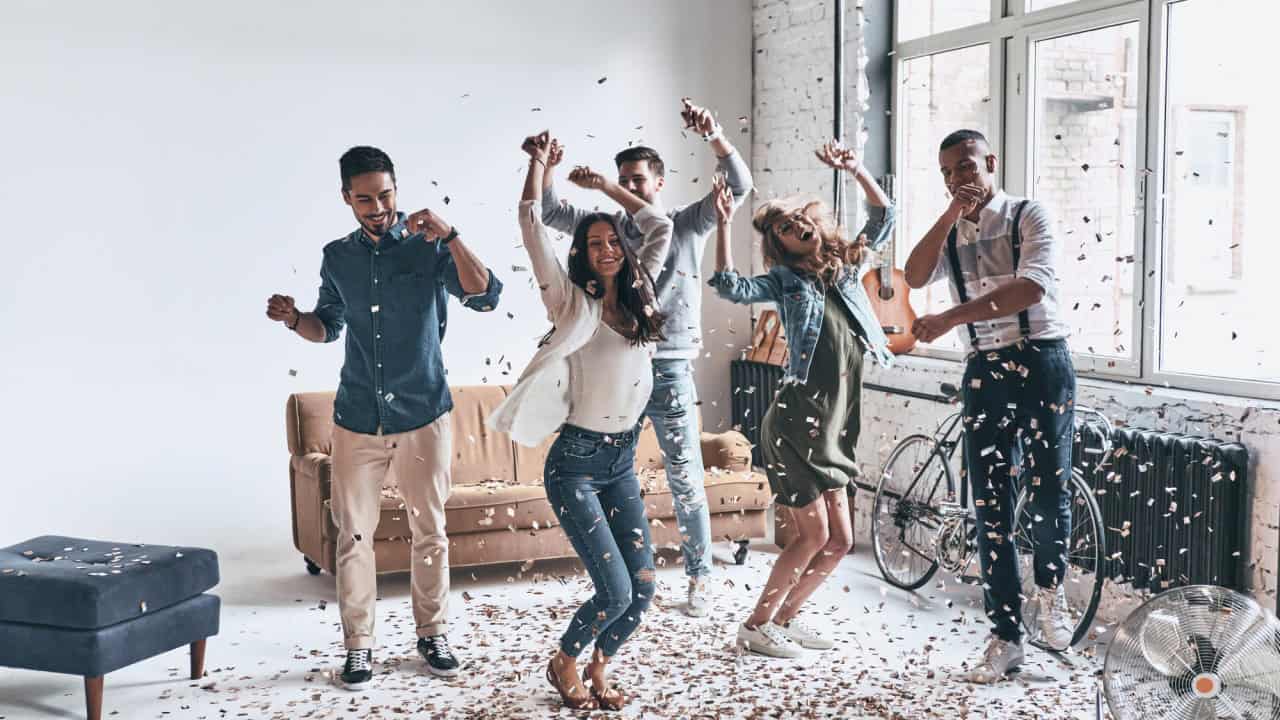 Happy young people having party at home