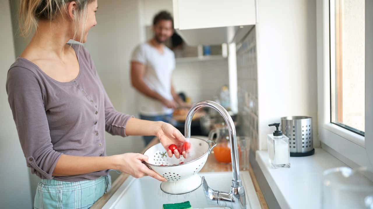 Lovely couple making breakfast together in the kitchen