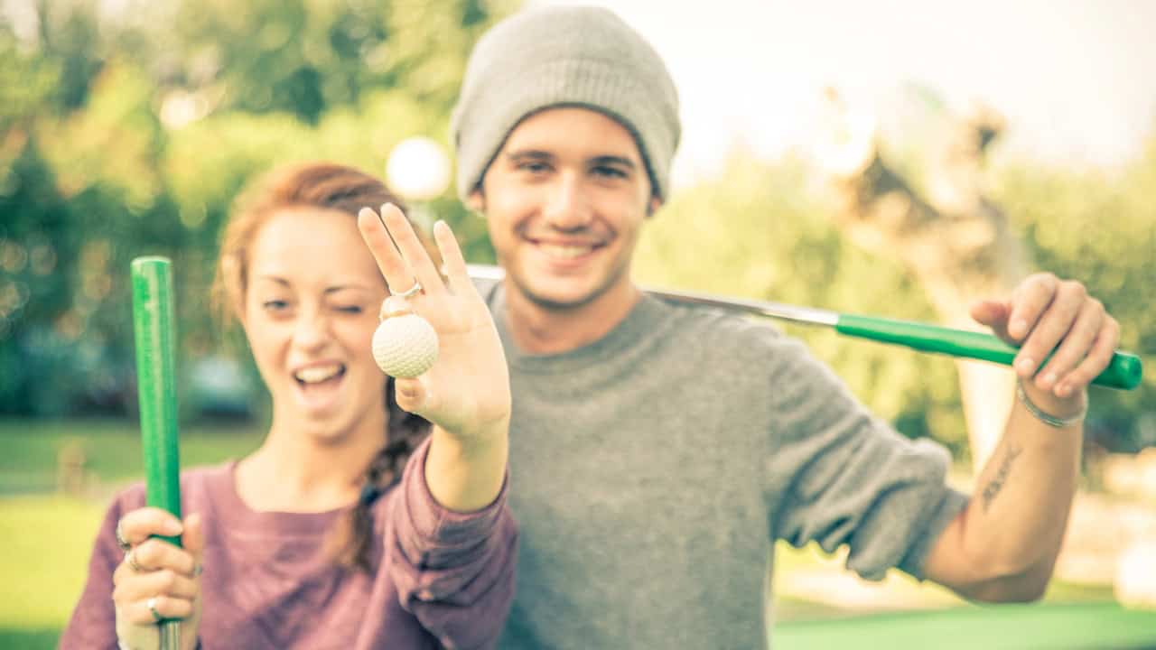 Couple playing golf