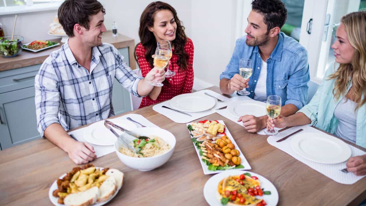 Smiling couple friends eating together 