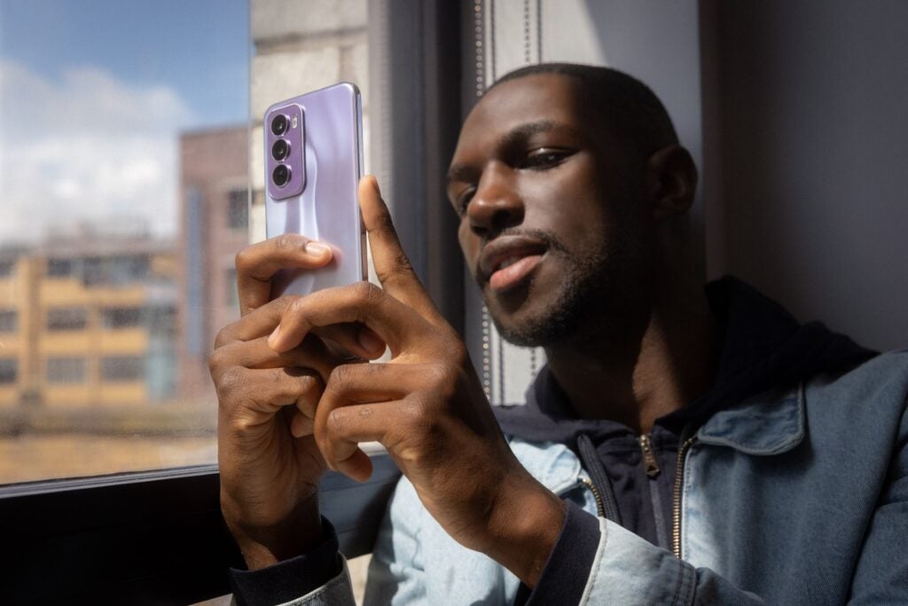 Person holding Oppo Reno 12 Pro phone