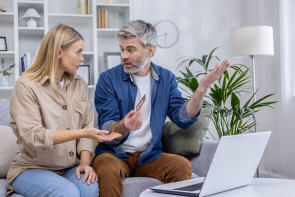 Mature couple arguing about online credit card fraud