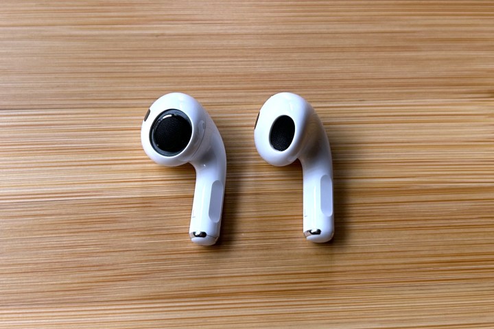 Apple AirPods Pro 2 seen with ear tip removed, beside an Apple AirPods 3 earbud.