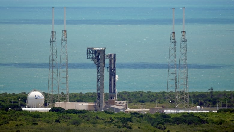 A launch pad and space capsule is pictured from far away.