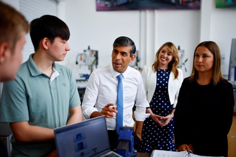 Britain's Prime Minister and Conservative Party leader Rishi Sunak speaks with students during a visit of University Technical College (UTC) in Silverstone, central England, on June 11, 2024.