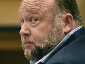 FILE - Infowars founder Alex Jones appears in court to testify during the Sandy Hook defamation damages trial at Connecticut Superior Court, Sept. 22, 2022, in Waterbury, Conn. Relatives of victims of the Sandy Hook Elementary School shooting are asking a bankruptcy judge to liquidate Jones' media company including Infowars instead of allowing him to reorganize his business, as they seek to collect on $1.5 billion in lawsuit verdicts against him.