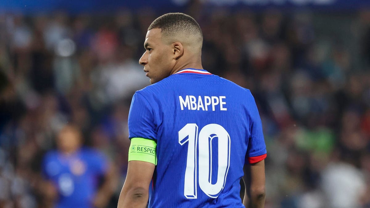 France forward Kylian Mbappe looking over his left shoulder with his back to the camera.