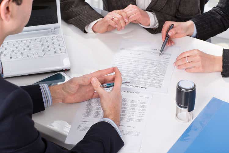 hands of three people, signing documents