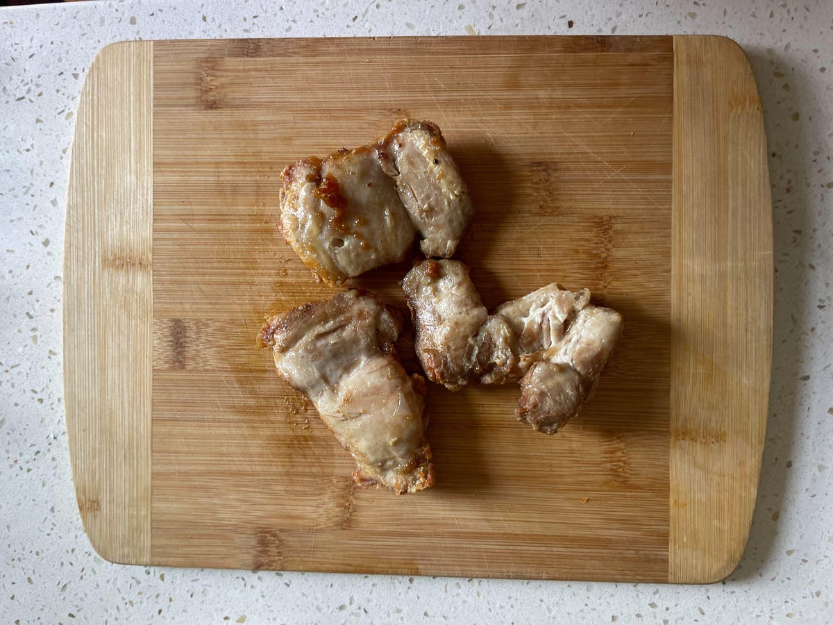 chicken on cutting board having just been cooked in air fryer