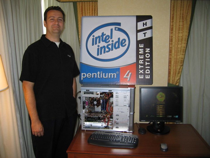 Someone standing in front of an Intel Pentium 4 sign.