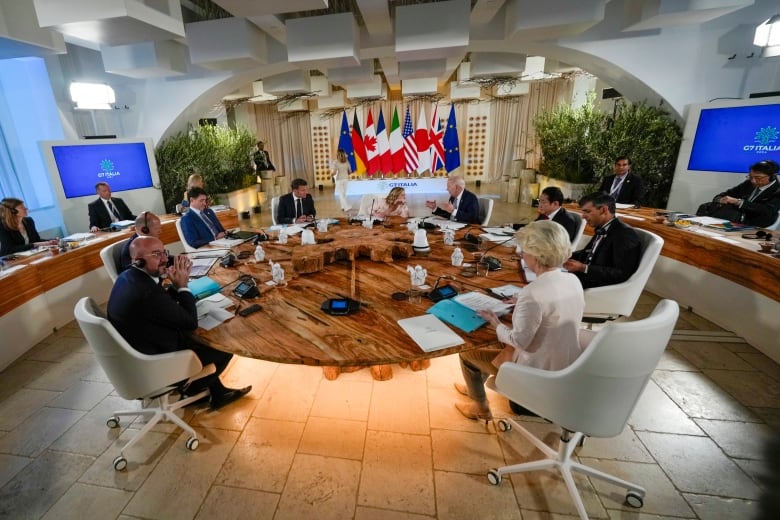 Clockwise from left, European Council President Charles Michel, German Chancellor Olaf Scholz, Canada's Prime Minister Justin Trudeau, French President Emmanuel Macron, Italian Prime Minister Giorgia Meloni, U.S. President Joe Biden, Japan's Prime Minister Fumio Kishida, Britain's Prime Minister Rishi Sunak and European Commission President Ursula von der Leyen participate in a working session during a G7 summit at Borgo Egnazia, Italy, Thursday, June 13, 2024. 