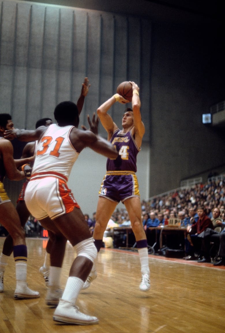 Male basketball player of the Los Angeles Lakers shoots against the Baltimore Bullets during an NBA basketball game circa 1970 at the Baltimore Civic Center in Baltimore, Maryland. West played for the Lakers from 1960-74. 