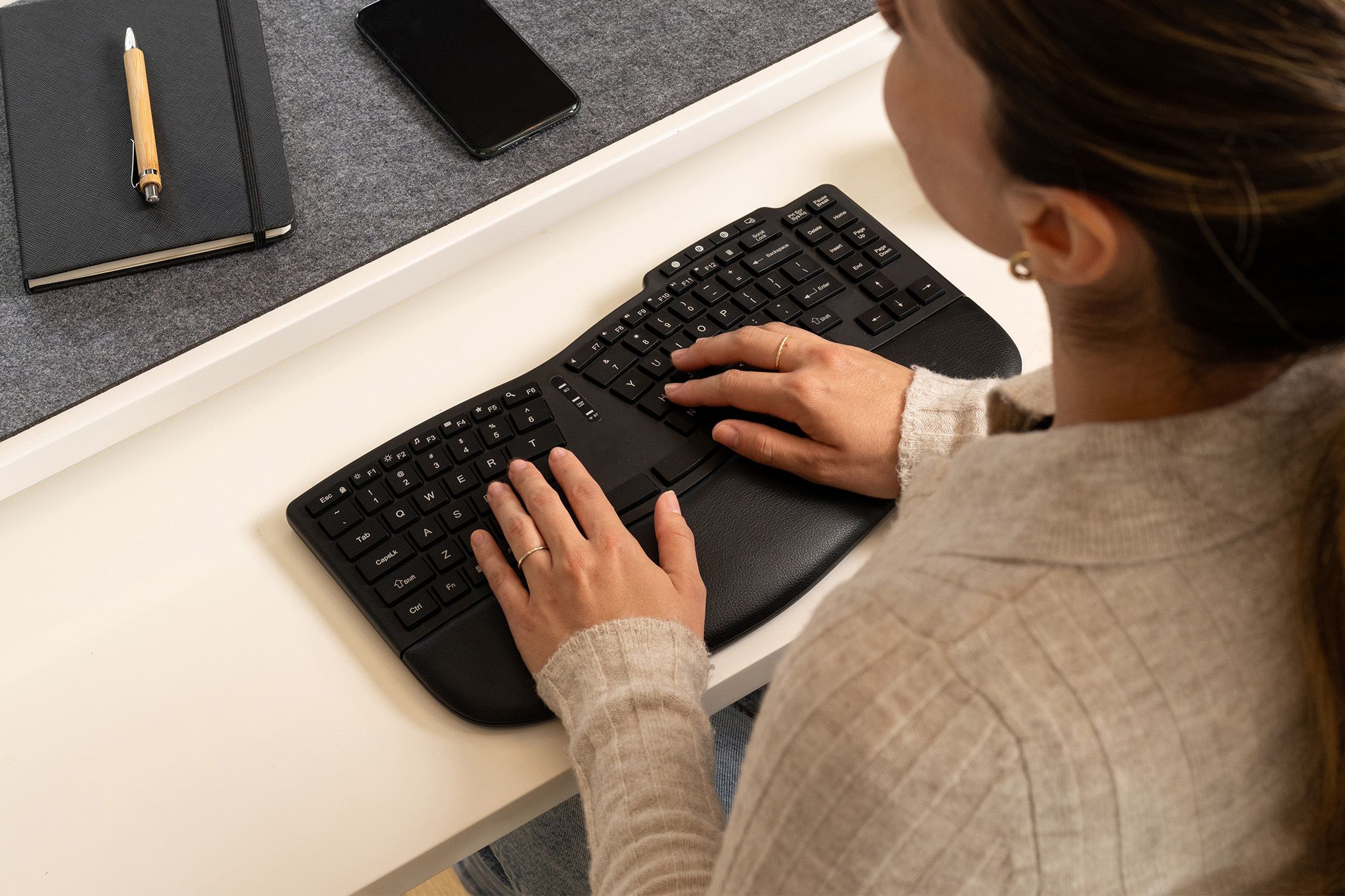 Person at a desk typing on the Kensington ergonomic keyboard