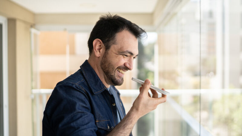 A man talks into a smartphone.