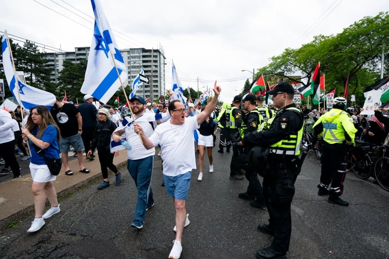 Pro-Israeli marchers react to Pro-Palestinian protesters gathered along the route of the United Jewish Appeal’s annual Walk With Israel march in Toronto, on Sunday, June 9, 2024.