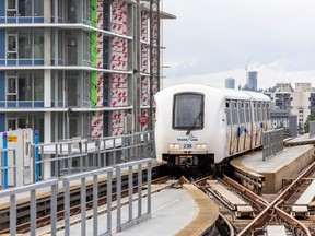 A skytrain travels through Burnaby in the shadow of newly built condominium towers.