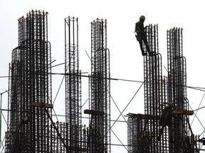 worker dangles in the air