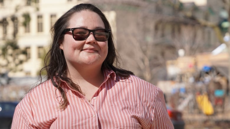 a woman wearing sunglasses and a striped shirt